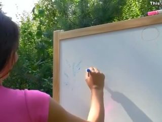 Bewitching strap on fuck with young artist outdoor video
